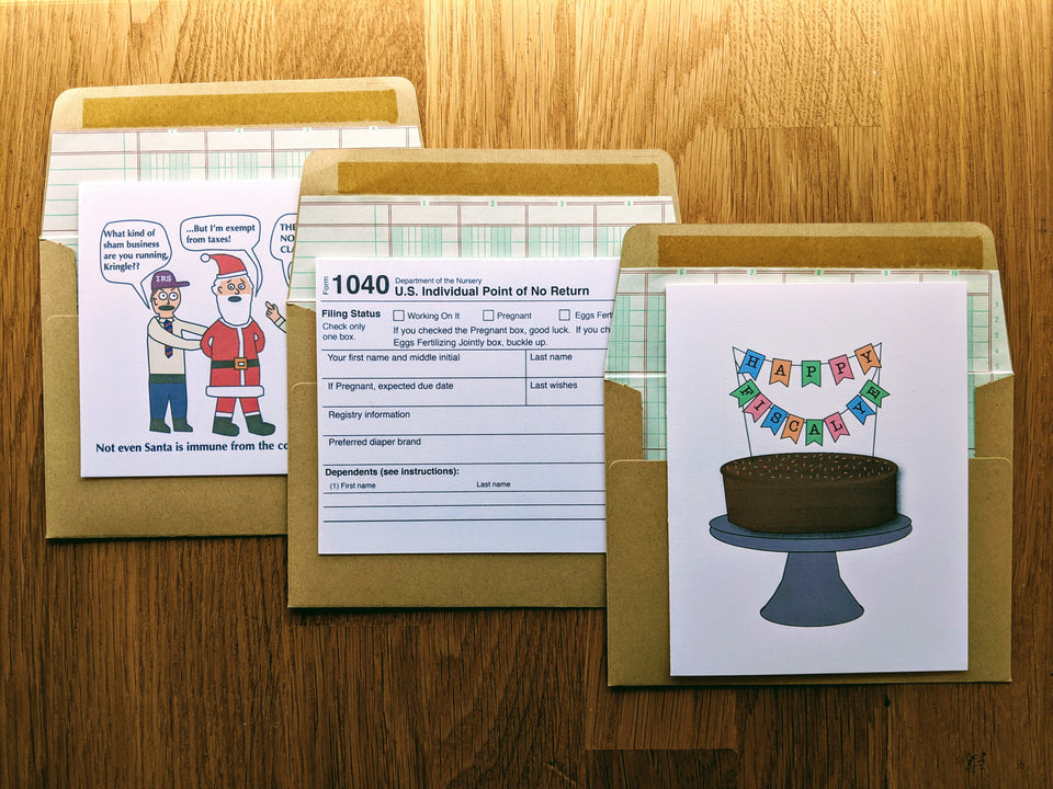 Image of three accounting themed greeting cards atop ledger paper lined kraft style envelopes