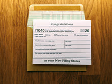 Load image into Gallery viewer, Accounting greeting card parodying a Form 1040 with the &quot;Married Filing Jointly&quot; box checked, with &quot;Congratulations on your New Filing Status&quot; printed on the top and bottom of the card.
