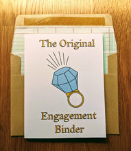 Load image into Gallery viewer, Accounting greeting card atop ledger-paper lined kraft envelope.  The card has an oversized diamond ring in the middle, with writing that states "The Original Engagement Binder".
