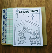 Load image into Gallery viewer, Accounting greeting card with three wise men bringing gifts to baby Jesus and mentioning that they assume he is set up as a 501c3, atop a ledger paper-lined envelope.