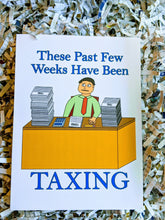 Load image into Gallery viewer, Accounting greeting card with accountant at desk which has from left to right a giant stack of Form 1040, a 10-key calculator, a Form 1040, a pencil, and another large stack of Form 1040 slightly shorter than the first