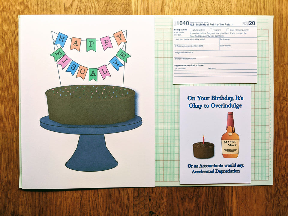 Three accounting themed birthday greeting cards arranged on top of a sheet of ledger paper