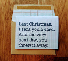 Load image into Gallery viewer, Accounting greeting card with ledger paper background that states Last Christmas I sent you a card, and the very next day, you threw it away. Card is atop a ledger-paper lined kraft style envelope.
