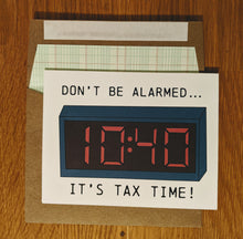 Load image into Gallery viewer, Accounting themed greeting card that says &quot;Don&#39;t be alarmed, it&#39;s tax time!&quot; with a picture of a digital alarm clock where the time is 1040, sitting atop a ledger paper-lined kraft style envelope.
