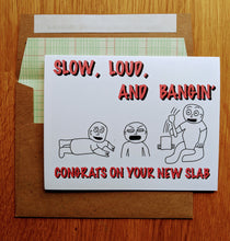 Load image into Gallery viewer, Greeting card that says Slow Loud and Bangin, with image of a crawling baby, crying baby, and baby banging a spoon on a pot, with text on the bottom that reads Congrats on your new SLAB.
